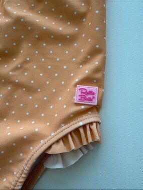 Ruffle Butts Peach Polka Dot Ruffle Swim Bottom with Pink Logo